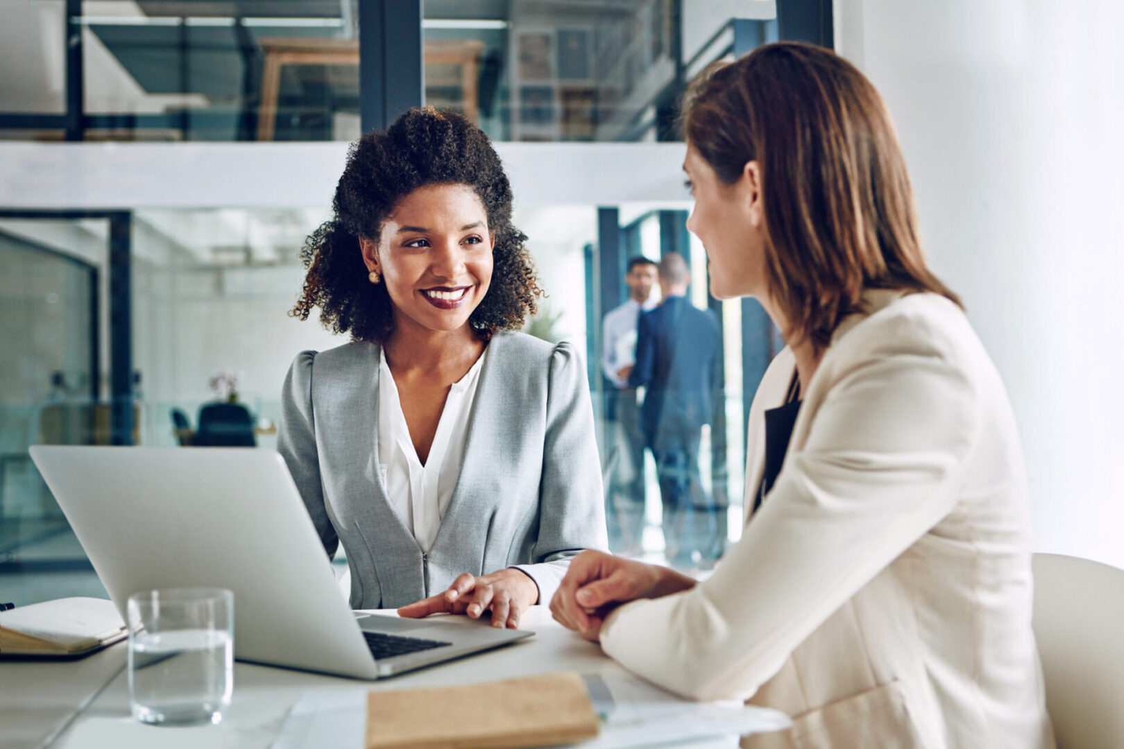 Cropped shot of two corporate businesswomen having a discussion in an office