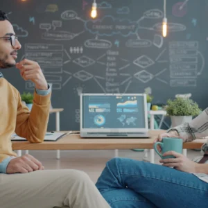 Two consultants discussing strategy in a modern workspace